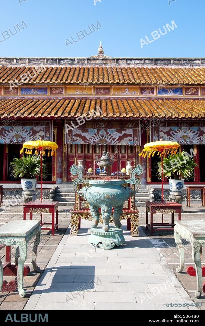 The Th? Mi?u, also called Th? T? Mi?u, is an ancestral temple and was constructed on the orders of Emperor Minh M?ng in 1822-1823. It honours the emperors of the Nguy?n Dynasty. Nine dynastic urns (Vietnamese c?u d?nh ??) in front of the Th? Mi?u were also cast in 1822 and dedicated to the first nine Nguyen emperors. Emperor Gia Long ordered the construction of Hue Citadel in 1805. The vast complex is built according to the notions of fengshui or Chinese geomancy, but following the military principles of the noted 18th century French military architect Sebastien de Vauban. The result is an unusual and elegant hybrid, a Chinese-style Imperial City carefully aligned with surrounding hills, islands and waterways, but defended by massive brick walls between 6-12 metres high and 2.5 metres thick, punctuated by towers, ramparts, a massive earth glacis, and 24 Vauban-inspired bastions. The entire complex was further protected by wide moats, crossed by gracefully arched stone bridges leading to ten gates, the chief of which is Cua Ngo Mon, the south-east facing ‘Meridian Gate’. To compound the exotic hybrid effect, guard posts designed as Chinese-style miradors, complete with sweeping eaves crowned by imperial dragons, surmounted each gate. Finally, directly in front of the Ngo Mon Gate, a massive brick fort 18 metres high was constructed both as an additional barrier against malign spirits, and as a defensive redoubt. The area within the Citadel - in all, 520 hectares (1300 acres) - comprises three concentric enclosures, the Civic, Imperial and Forbidden Purple Cities. Access is by way of ten fortified gates, each of which is reached by a low, arched stone bridge across the moat. In imperial times a cannon would sound at 5am and 9pm to mark the opening and closing of the gates. Hue was the imperial capital of the Nguyen Dynasty between 1802 and 1945. The tombs of several emperors lie in and around the city and along the Perfume River. Hue is a UNESCO World Heritage Site.