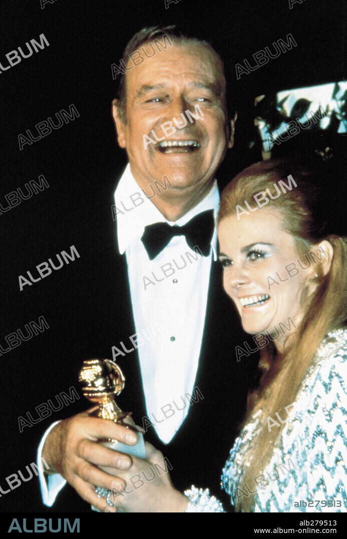 ANN-MARGRET and JOHN WAYNE. The 42nd Academy Awards (1970) John Wayne winner as best actor for "True Grit". He is with actress Ann-Margret. 1970