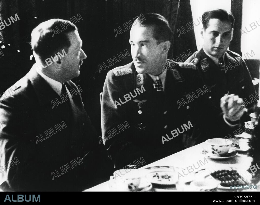 Adolf Hitler in conversation with German air force fighter ace Adolf Galland, 1941. Prior to the Second World War Galland (1912-1996) served with the Condor Legion in the Spanish Civil War. By the end of 1941, with 94 victories to his name, he was chosen by Hermann Goring to command Germany's fighter forces. He is pictured here in January 1941 with Hitler during a visit by the Fuhrer to the front when Galland was commander of the 26th Fighter Wing.