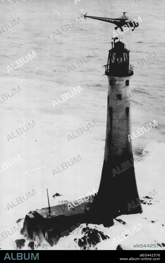 Helicopter Relieves Wolf Rock - A dramatic picture as the Helicopters  hovers over the Wolf Rock lighthouse while the heavy seas surge around the  base of the light-house as - Album alb5442576