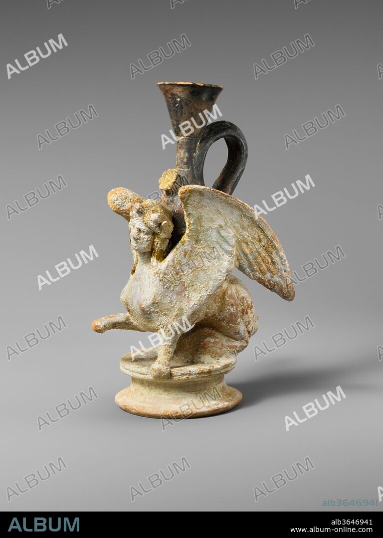 Terracotta lekythos (oil flask) in the form of a sphinx. Culture: Greek, Attic. Dimensions: H. 5 5/8 in. (14.3 cm.). Date: ca. 380-360 B.C..
Many traces of paint remain on this sphinx: pale blue on the wings and the eyes, red on the lips, and gold on the fillet.