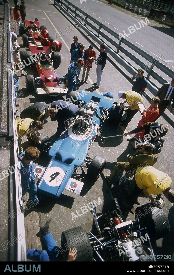 Cars at the British Grand Prix, Silverstone, Northamptonshire, 1969. In the centre of the picture is a blue Matra-Ford, with a Lotus immediately behind it in the pit lane. Jackie Stewart won the race in a Matra-Ford.