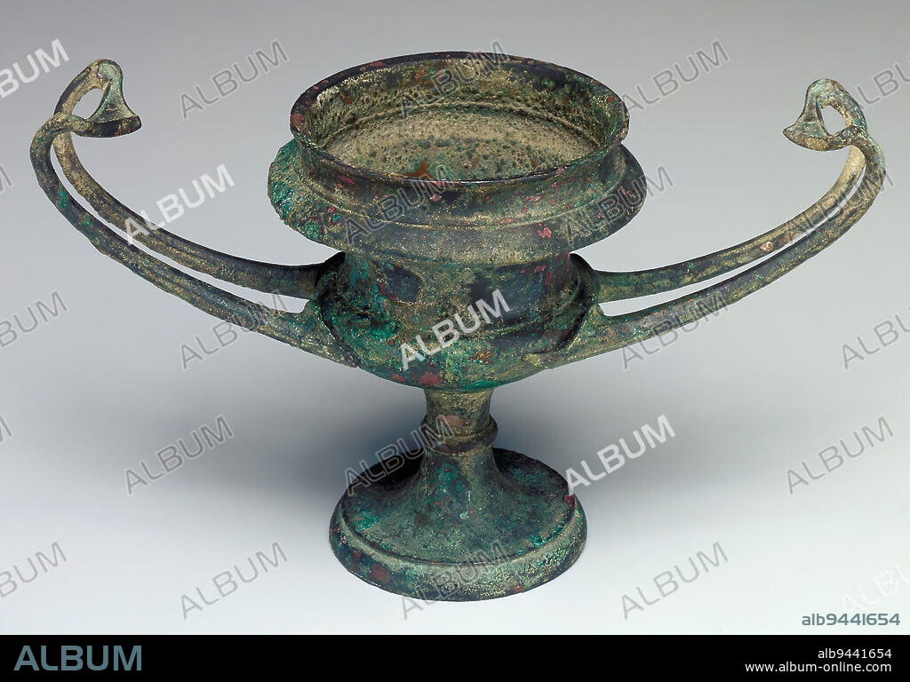 Kantharos, 5th century BCE, 3 11/16 x 6 15/16 x 3 3/16 in. (9.37 x 17.62 x 8.1 cm), Bronze, Greece, 5th century BCE, The kantharos (plural, kantharoi), a type of drinking cup with two high loop handles and a deep bowl, is particularly associated with Dionysos, the Greek god of wine and vegetation. Its horizontal handles make this cup unusual, since they more closely resemble those of a shallower type of cup known as a kylixthan those of other kantharoi. Since few ceramic examples of kantharoi survive, it is believed that they were more usually made of bronze, silver, or gold. Metal examples, often destroyed by corrosion or melted down for other uses, are also rare.