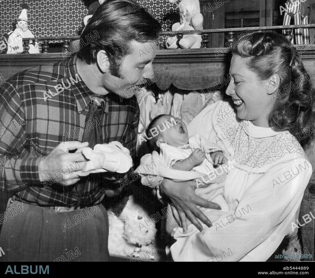 Dinah's Baby Bored Melissa Ann Montgomery, daughter of Dinah Shore and her actor-husband, George Montgomery, registers an expressive yawn as she poses for first pictures with her parents in their San Fernando Valley, Calif. home, Feb. 1. February 4, 1948. (Photo by Associated Press Photo).