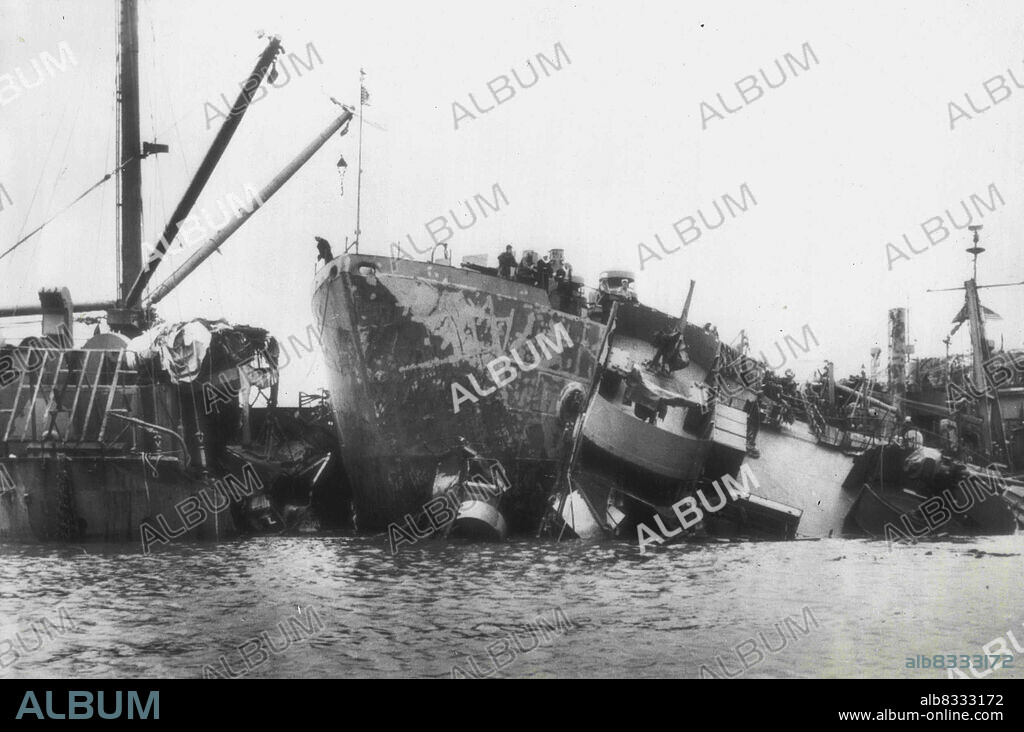 Ships Collide During Okinawa Typhoon: Wreckage of the S.S.Ocelot lies awash in Buckner Bay, Okinawa, with the bow of an ARB (repair ship, battle damage) poking into the debris after the ships were driven together by the Typhoon which swept the island Oct.9. Some 130 Navy vessels were driven aground by the 140 mile-an-hour wind and 20 foot waves. October 15, 1945. (Photo by AP Wirephoto).