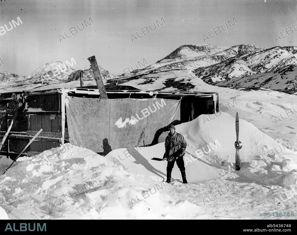 British Arctic Air Route Expedition: Snow drifts in front of the hanger at the Base Camp. July 30, 1931. (Photo by Ft. Lt. Cozens, British Arctic Air Route Expedition Photograph).