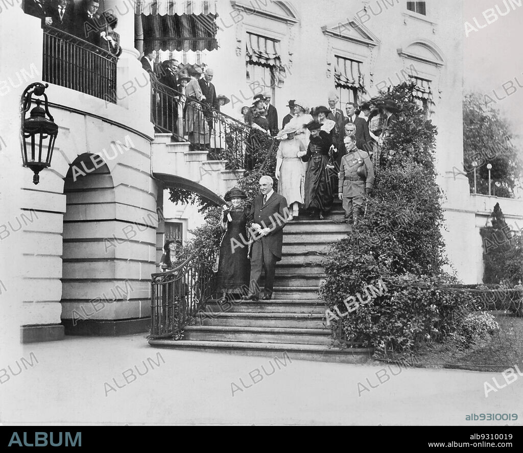 U.S. President Warren G. Harding escorting Marie Curie down steps to south  grounds of White House, Washington, D.C., USA, National Photo Company, May  1921 - Album alb9310019