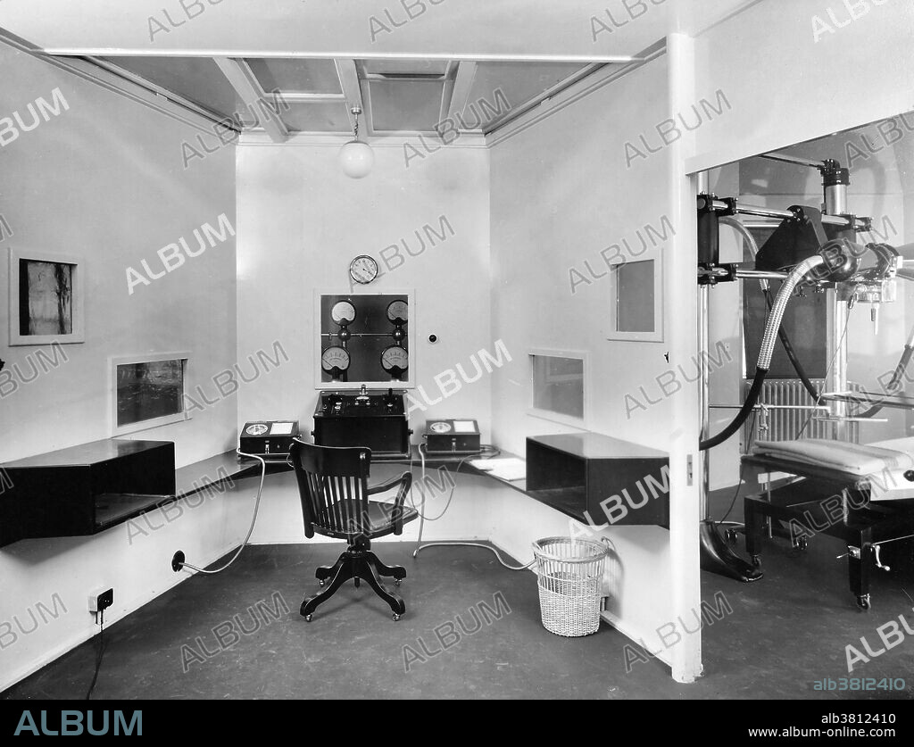 Photograph showing the interior of the X-ray department at the Marie Curie Hospital for Cancer and Allied Diseases, London, 1934. Depicted are the control board, dosimeters, and windows for viewing patients and instruments. Founded by medical women for the "radiological treatment of women suffering from cancer and allied diseases," the hospital opened in 1929 with the encouragement of Marie Curie, who allowed her name to be used, and it was staffed entirely by women.