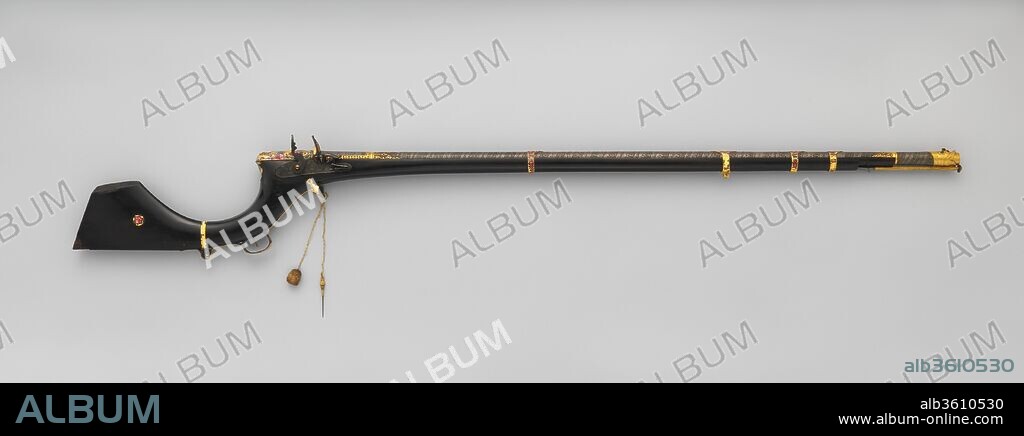 Flintlock Gun. Culture: Indian, Sindh (now Pakistan); lock, British. Dimensions: L. 58 7/8 in. (149.5 cm); L. of barrel 42 3/4 in. (108.6 cm); Cal. .56 in. (14.0 mm); Wt. 9 lb. 11 oz. (4393 g). Date: second quarter of the 19th century.
Guns of this type, with sharply curved flaring butts and mounts in enameled gold of Iranian manufacture, are typical of Sind, now a province of southern Pakistan. The British lock is inscribed "H. M.," possibly referring to the well-known London gunmaker Harvey Walklate Mortimer (1753-1817). It may be a remnant of the firearms given to the mirs, rulers of Sind, by the British government. The barrel, possibly made locally, is of boldly patterned Damascus steel. The gilt muzzle is in the shape of a dragon's head, the eyes set with rubies and emeralds.