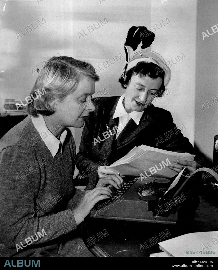 Gwen Meredith (right) and Gwen Plumb. Miss Plumb at the typewriter, and Miss Meredith with the hat - worrying over a knotty problem in the script of Blue Hills. The show eventually came to an end because Miss Meredith after all the years of writing it, decided to call it a day. Dater of this picture? 1952. August 18, 1952. (Photo by Peter Leyden).