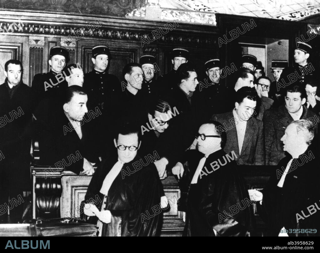 Trial of French members of the Gestapo, Paris, 1-12 December 1944. The defendants, from left to right, are Henri Lafont, Pierre Bonny and Paul Clavie, Lafont's nephew. They are defended by Messrs Floriot, Delaunay and Casanova. Bonny, a police inspector before the war, was apprehended on 18 September 1944 disguised as a tramp. The three were found guilty of collaboration and executed on 27 December.