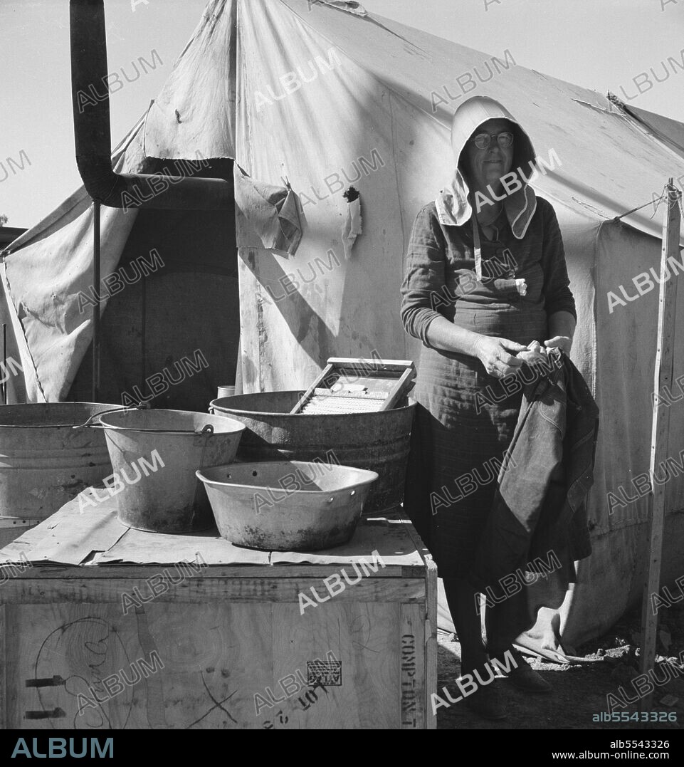 DOROTHEA LANGE. Texas woman in carrot pullers' camp. Imperial Valley, California. This sunbonnet is typical of women who came from Texas.