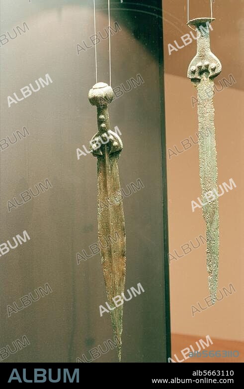 Prehistory / Weapons. Two bronze swords. Middle Bronze Age, Ottoman Culture between central Danube and West Carpathians, 16th century B.C. (Length of left sword: 62cm, right sword: 56.5cm). From the Apa Traesure, Jewish Satu Mare. (Romania). Bucharest, Natural History Museum.