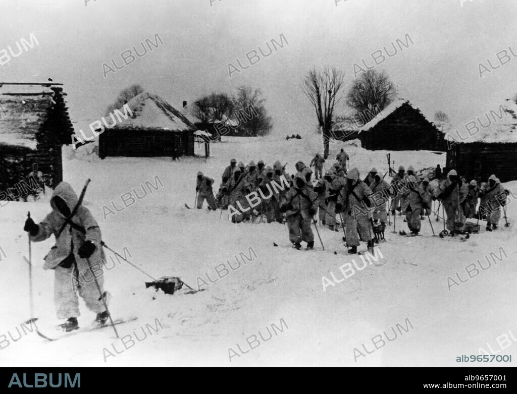 German soldiers on skis leaving a village, probably middle section of the Eastern Front. Photo: Gefr. Gebauer. [automated translation].