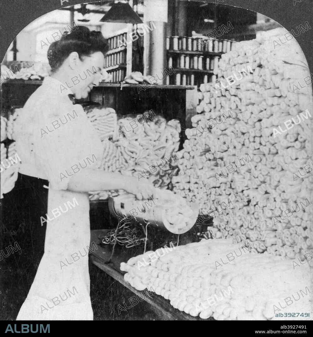 Weighing and sorting raw silk skeins, South Manchester, Connecticut, USA, early 20th century. Stereoscopic card. Detail.