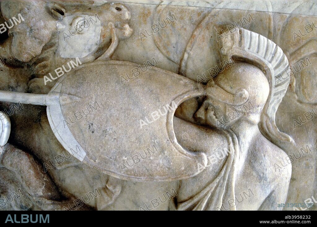 Greek Hoplite in battle against the Amazons (30BC-200AD?). Hoplites were heavily armed Greek foot soldiers who fought in close formation. Their equipment included a shield carried on the left arm and a plumed metal helmet. Detail from a sarcophagus of the Roman Imperial epoch, Vatican Museum, Rome.