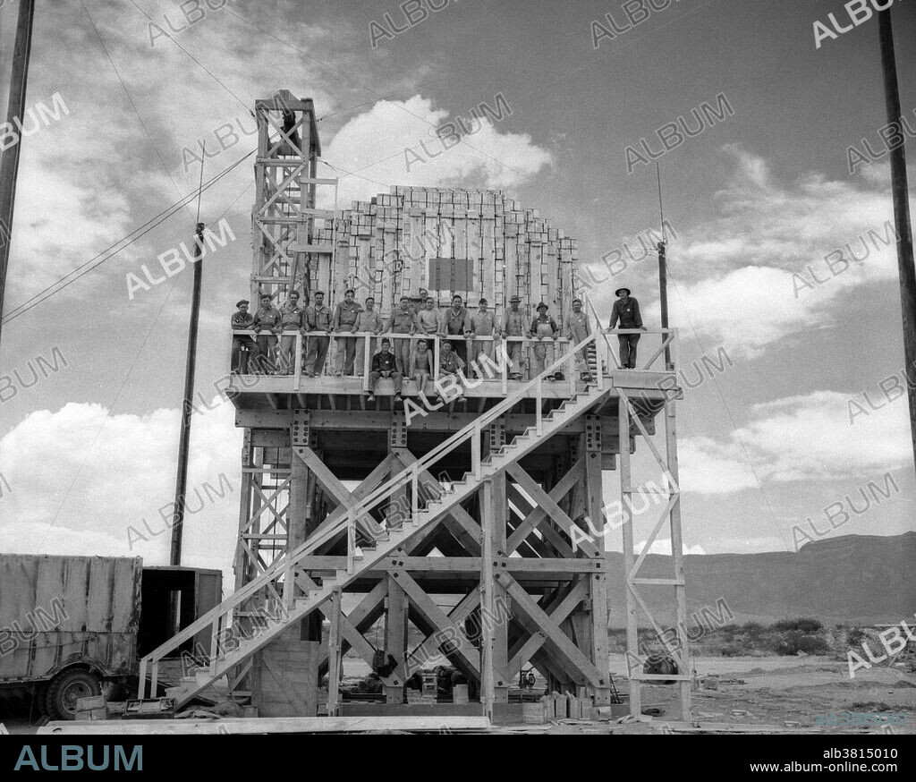 Trinity Test Site. The Manhattan Project was a research and development program by the US with the UK and Canada that produced the first atomic bomb during WWII. From 1942-46, the project was under the direction of Major General Leslie Groves of the US Army Corps of Engineers. Because of the complexity of an implosion-style weapon, it was decided that an initial test would be required. Groves approved the test, subject to the active material being recovered. Consideration was therefore given to a controlled fizzle, but Oppenheimer opted instead for a full-scale nuclear test, codenamed Trinity. Bainbridge selected the bombing range near Alamogordo Army Airfield as the site for the test. A base camp was built to house staff. A one-hundred foot shot tower was designed and constructed at ground zero. Concrete bunkers to house cameras and other diagnostic equipment popped up in a rough circle around ground zero. A commitment had been made to test the gadget "as soon after July 15th as possible," and before or during the upcoming Potsdam Conference. TNT Trinity Test occured on July 16th.