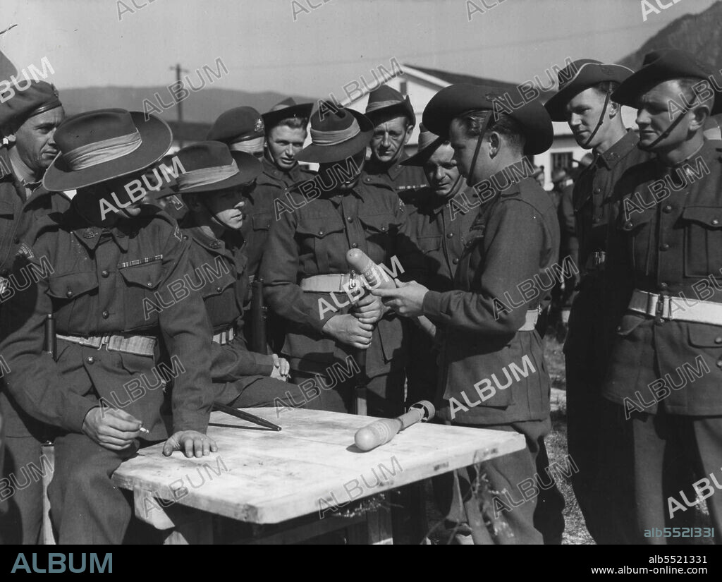 A Bazooka projectile is not large as missiles go, but it carries a mighty wallop in its nose. These reinforcements for Third Battalion, Royal Australian Regiment, are learning the drill about the bazooka at a BCOF base camp before moving over to join their mates in the Korean fighting. All these men have heard about the bazooka's tank-busting properties. Now they are waiting their chance to test them in action against the reds. November 17, 1950.