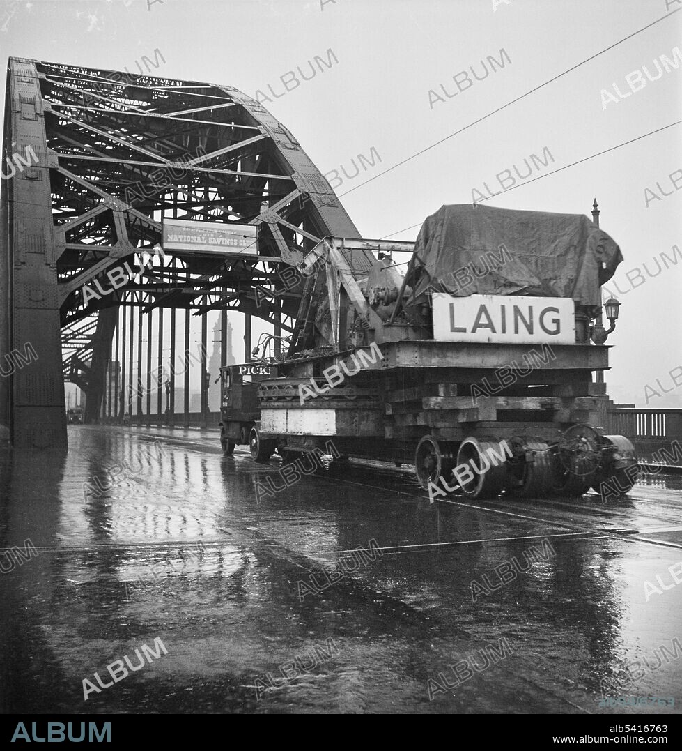 JOHN LAING PLC. A Pickfords low loader transporting a W90 walking dragline excavator across the Tyne Bridge on its journey to Whitley Bay opencast coal site. This photograph is part of a batch showing a Ransome Rapier W90 walking dragline excavator being transported through the streets of Newcastle-upon-Tyne. It was on a 280 mile journey from one Laing contract at Carrington Coppice opencast coal mine in Derbyshire to another at Whitley Bay opencast coal mine.