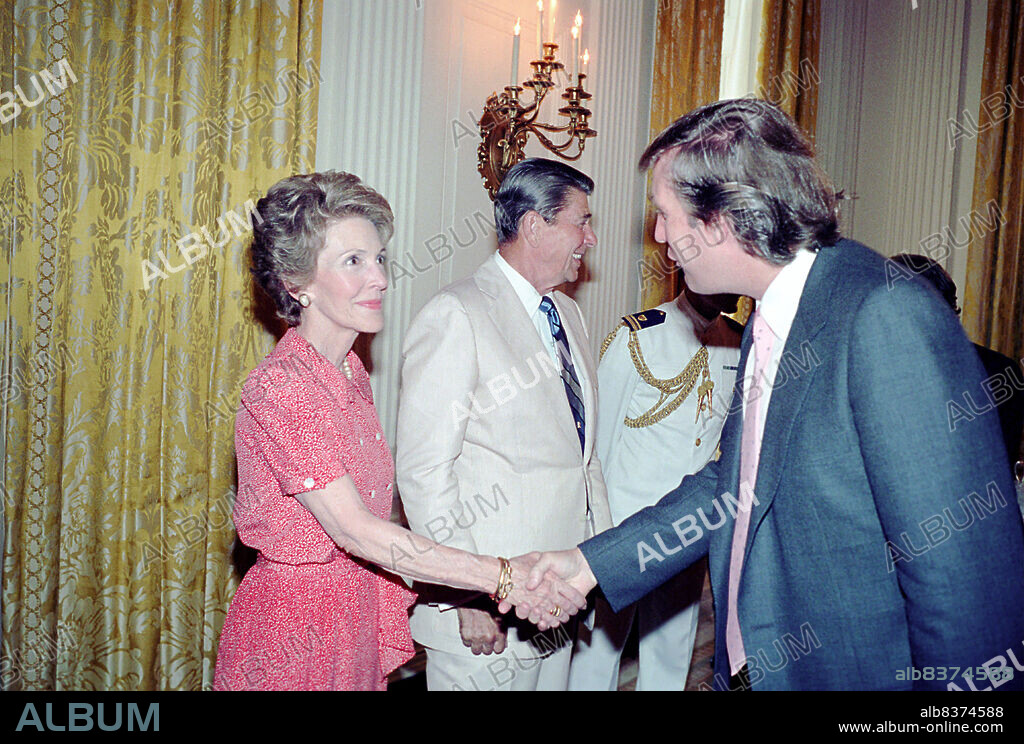 President Ronald Reagan and Nancy Reagan greet Donald Trump (right) in the White House State Dining Room during a reception for Eureka College Scholarship recipients, Washington, DC, 8/4/1983.