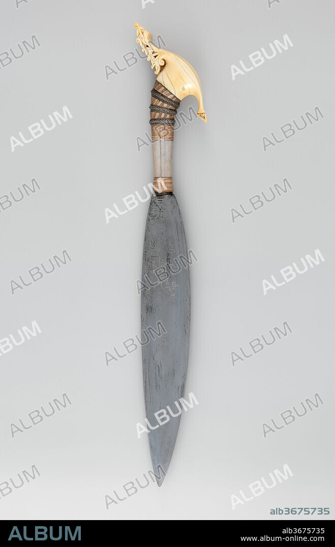 Knife (Barong) with Sheath. Culture: Philippine, Jolo Island or Zamboanga Peninsula. Dimensions: L. with sheath 28 in. (71.1 cm); L. without sheath 24 in. (61 cm); L. of blade 15 in. (38.1 cm); W. 3 5/8 in. (9.2 cm); Wt. 1 lb. 10.8 oz. (759.8 g); Wt. of sheath 7.9 oz. (224 g). Date: 19th century.
The barong is a knife distinct to the Muslim people of the southern Philippines. On both sides of this barong's blade is an image of <i>Dhu'l Fiqar</i> with the word "Allah" inscribed in Arabic within its contours. The legendary sword is surrounded by Arabic letters and numbers, which are the result of esoteric talismanic calculations tailored to the weapon's owner. Each letter and number most likely signifies Qur'anic passages or other pious phrases that were intended to protect from harm and danger.