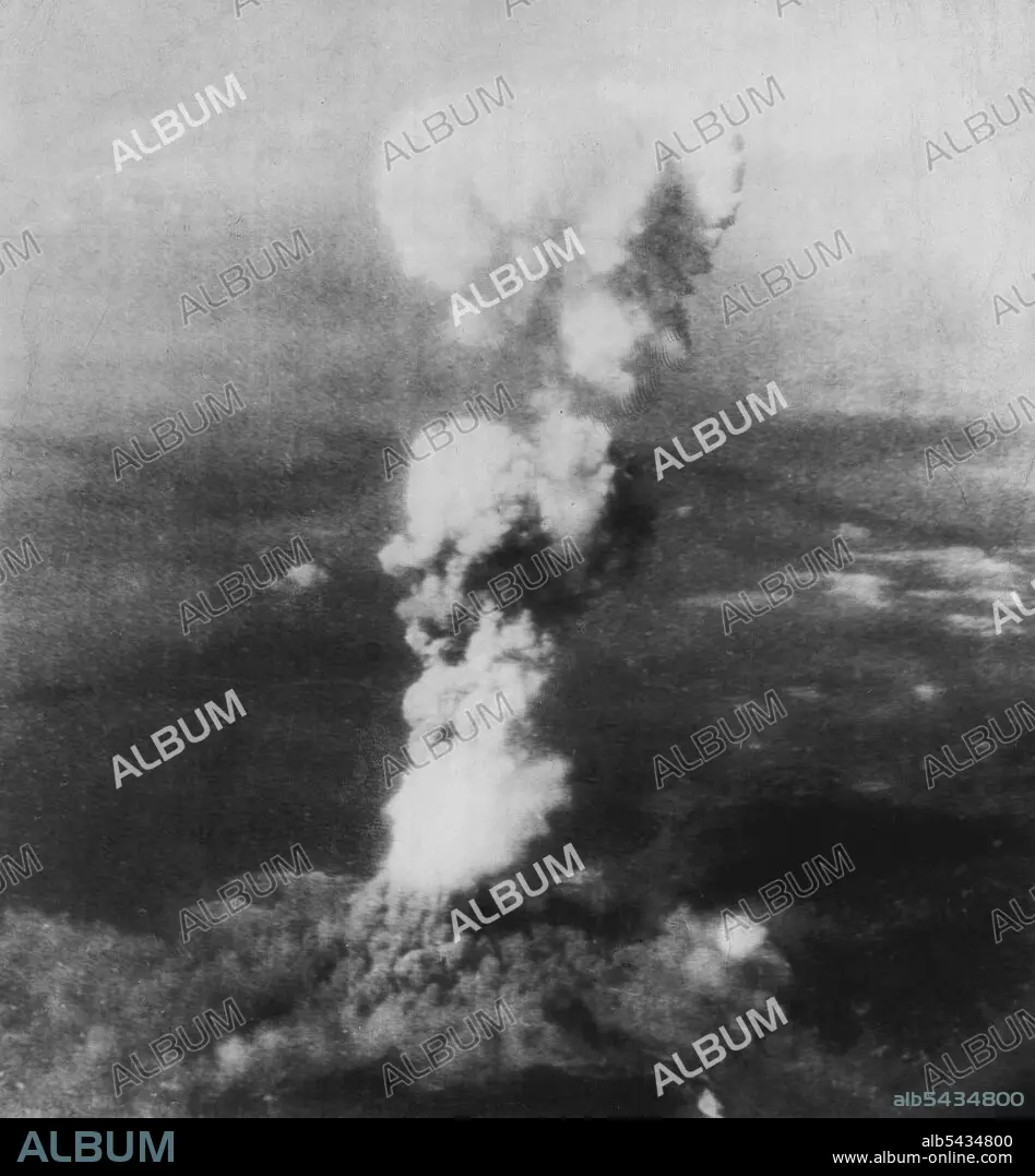 First Atomic Bomb Bursts On Japan -- A tall column of smoke 