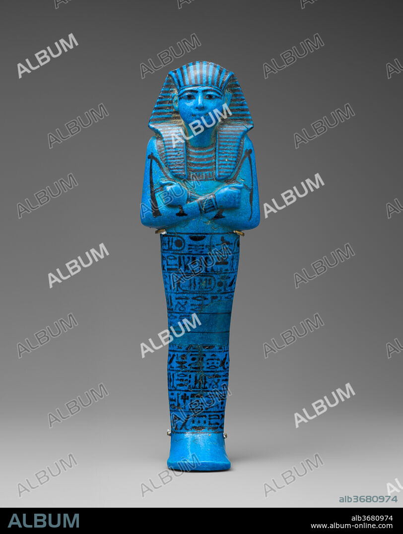 Shabti of Seti I. Dimensions: H. 30.5 × W. 8.8 × D. 6.5 cm (12 × 3 7/16 × 2 9/16 in.). Dynasty: Dynasty 19. Reign: reign of Seti I. Date: ca. 1294-1279 B.C..
This shabti was one of hundreds made for the pharaoh Seti I, the father of Ramesses II. Shabtis were placed in a tomb so the owner's spirit would not have to perform manual labor in the afterlife. The figurines were often inscribed with the "shabti text" - chapter 6 of the Book of the Dead - a spell that exhorts the shabti to substitute itself if the owner is asked to till the fields, irrigate the land, or transport sand from east to west. To this end, even royal shabtis are often depicted clutching a pick and a hoe, and with a basket hanging over one or both shoulders. In this example, the king holds the hoe in his left hand and the pick in his right, but there is no basket on the back.