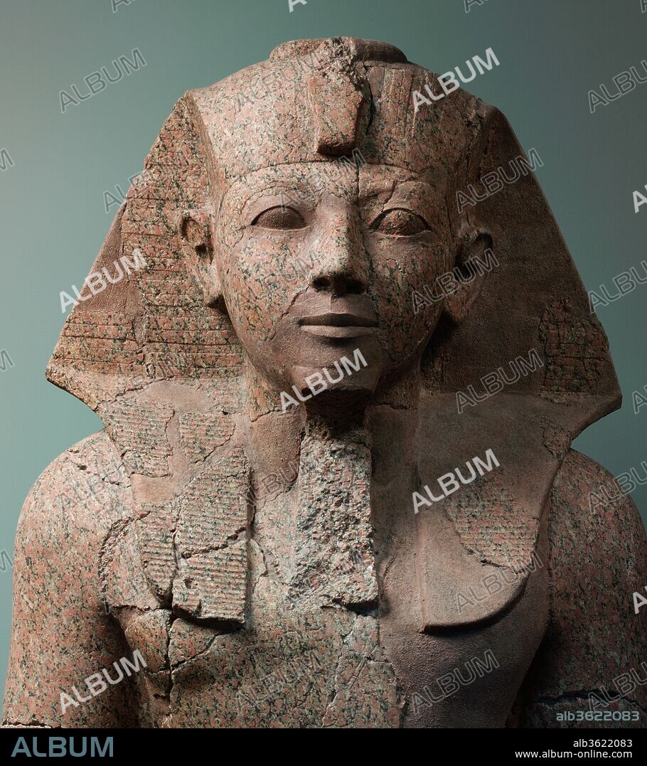 Large Kneeling Statue of Hatshepsut. Dimensions: H. 295.9 cm (116 1/2 in); w. 82.6 cm (32 1/2 in); d. 149.9 cm (59 in). Dynasty: Dynasty 18. Reign: Joint reign of Hatshepsut and Thutmose III. Date: ca. 1479-1458 B.C..
This over life-size kneeling statue and two others in the collection (29.3.1 and 30.3.1) were made to flank the processional pathway along the axis of Hatshepsut's temple at Deir el-Bahri. They depict Hatshepsut as the ideal Egyptian king - a young man in the prime of life. Each statue has an inscription that includes her personal name, Hatshepsut (literally <i>foremost of noblewomen</i>) and/or a feminine pronoun or verb form, so the masculine garb and physique were not intended to trick people into thinking that she was a man. 
Although traditionally the Egyptian throne passed from father to son, when the necessity arose, a female ruler was accepted. However, the trappings and symbolism associated with kingship were overwhelmingly masculine and the sculptors of this statue were following a tradition that extended back more than fifteen hundred years. In this tradition, the public image of the king, whether he was an infant, a frail old man or, in this case, a woman, was shown in the most powerful and imposing form - a young, vigorous man, or a human-headed lion-bodied sphinx (31.3.166). In this statue, Hatshesut wears the <i>nemes</i>-headcloth, false beard, and <i>shendyt</i>-kilt that are part of the standard regalia of the king.