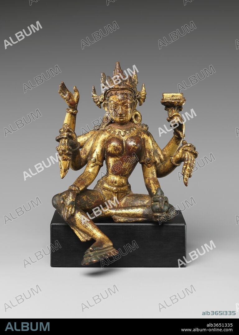 Vasudhara. Culture: Nepal, Kathmandu Valley. Dimensions: H. 5 5/16 in. (13.5 cm); W. 3 7/8 in. (9.8 cm). Date: 14th-15th century.
The Vasudhara-kalpa ritual text describes the six-armed Vasudhara (Sanskrit: "stream of gems") as a goddess of wealth, golden in color, who sits in royal ease holding her lower right hand in a boon-granting gesture (varada mudra) while jewels flow from her left.