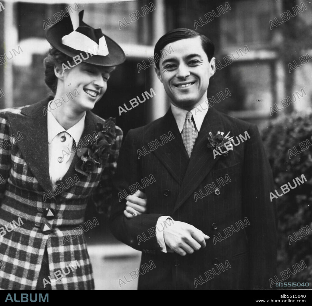 Prince Chula Of Siam Weds English Girl In London - Prince Chula and his bride leaving the register office after the wedding. 
Prince Chula-Chakrabongse of Siam and Miss Elizabeth Hunter, daughter of Mr. and Mrs. E.W. Hunter of Upper Philli more Gardens, London, were married a Marloes Flied register office, Kensington (London Prince Chula is 30 and his bride is 22. The Prince is a cousin of Prince Birabongse, the racing motorist. Permission for the wedding was granted by the King of Siam, and the ceremony was brought forward from October 15 because of the international situation. September 30, 1938.