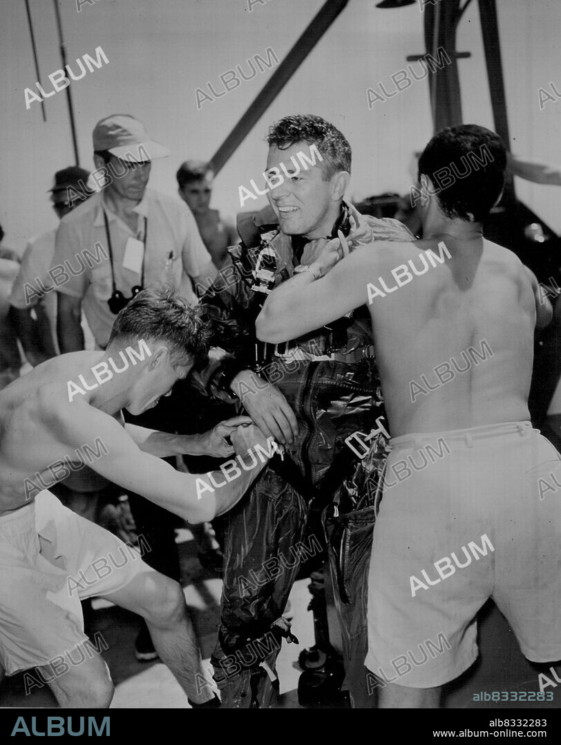 Nielsen doffs his soaking jump gear. Nielsen was jolted by the brutal wind  blast when he bailed out. Then, spinning uncontrollably at times, he fell  about six miles before - Album alb8332283