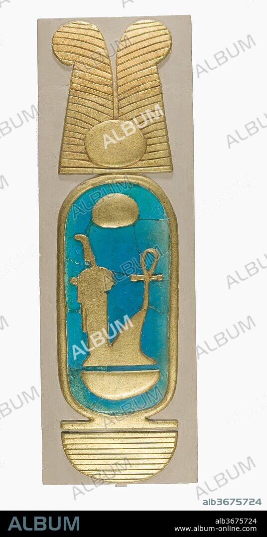 Reconstruction of a Cartouche of Amenhotep III. Dimensions: H. 52.1 cm (20 1/2 in); w. 15.4 cm (6 1/16 in); d. 5.4 cm (2 1/8 in.). Dynasty: Dynasty 18. Reign: reign of Amenhotep III. Date: ca. 1390-1353 B.C..
The blue faience tiles in this reconstruction were discovered during the Museum's excavations at Malqata, the site of a festival city built by Amenhotep III for the celebration of his three rejuvination festivals, or <i>heb seds</i>. The original cartouche was made of faience tiles and gilded plaster set into wood that was badly decayed and could not be preserved (see the excavation photograph above). In this reconstruction, the tiles have been set into plaster that has been painted to imitate gold leaf. The cartouche containes the king's throne name, <i>Nebmaatre</i>.
The original cartouche decoration was found in the Temple of Amun, which was built for the king's second heb sed. The excavators also found a long section of cornice decoration, and a group of tiles that had been used to create a geometric pattern, probabaly on a piece of temple furniture made of wood. the cornice and cartouche were also probably decorative elements of temple furniture.