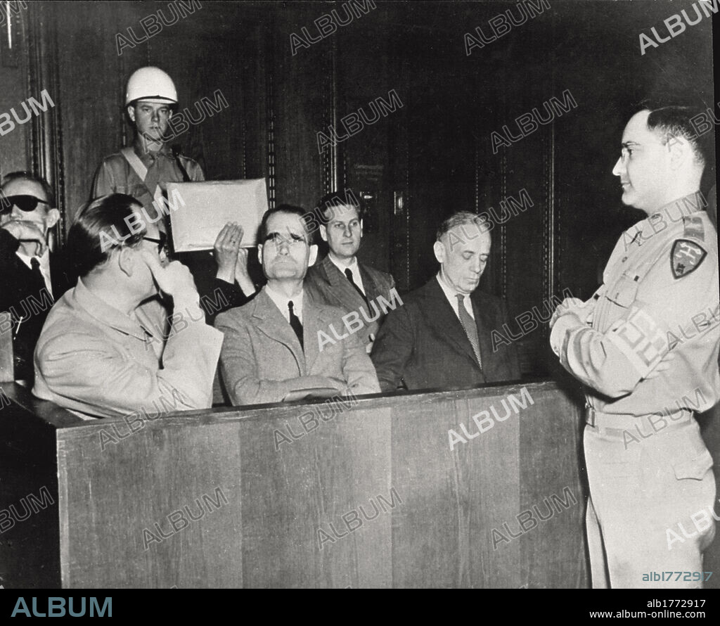 Defendants of war crimes. A sitting of the International War Crimes Tribunal. In the dock (first row from the left) Hermann Goering, Rudolph Hess, Joachin von Ribbentrop. In the second row, Karl Doenitz, Erich Raeder (who covers his face with an envelope) and Baldur von Schirach; in front of the dock, Gustav M. Gilbert, the prison psychologist. Nuremberg, 1946.