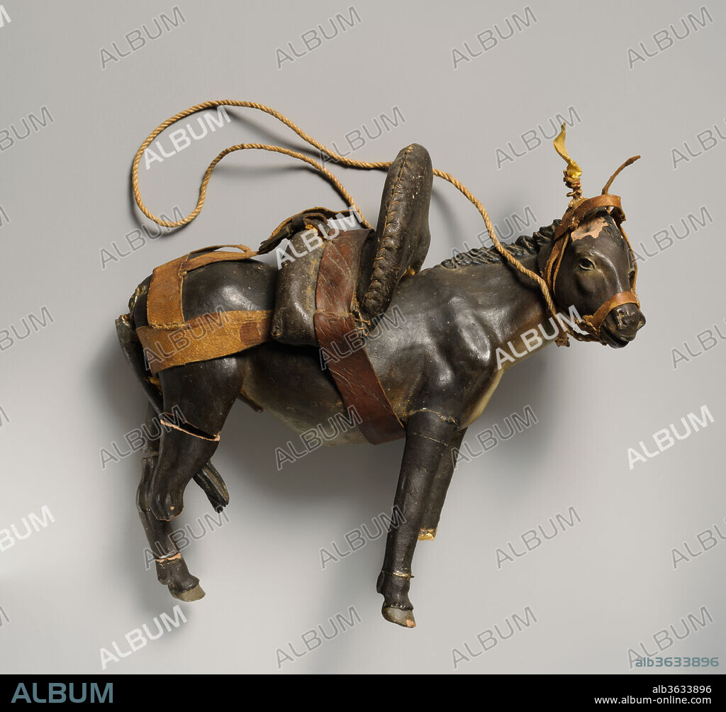 Donkey with saddle. Culture: Italian. Dimensions: Overall (.18a figure): 8 1/2 × 4 × 9 in. (21.6 × 10.2 × 22.9 cm); Overall (.18b head): 2 × 1 1/2 × 3 1/4 in. (5.1 × 3.8 × 8.3 cm); Overall (.18c PL rear leg): 3 3/4 × 7 × 3 in. (9.5 × 17.8 × 7.6 cm); Overall (.18d PL rear hoof): 1 × 3/4 × 7/8 in. (2.5 × 1.9 × 2.2 cm). Date: second half 18th-mid-19th century.
The practice of using crèche figures to restage religious events reached the height of its complexity and artistic excellence in eighteenth-century Naples, and the Metropolitan Museum of Art's group of Neapolitan crèche is one of the finest and most complete survivals of the art form. The ensemble consists of characters traditional to eighteenth-century Italian Christmas holiday customs. The Nativity, featuring the holy family, shepherds and their flocks, and a host of angels and cherubs is joined by the procession of the three Magi and colorful peasants, townspeople, and animals. The figures have articulated bodies of tow and wire with polychromed terracotta heads, and are all in partially distressed condition.
These vibrant characters are further brought to life by a wide-ranging set of cloth, embroidery, leather, wicker, wax, and silver accessories. Many of these, such as the figures' luxurious costumes, baskets of fruit, and gilt censers are original, and represent forms traditional to the rural areas around Naples during this period.