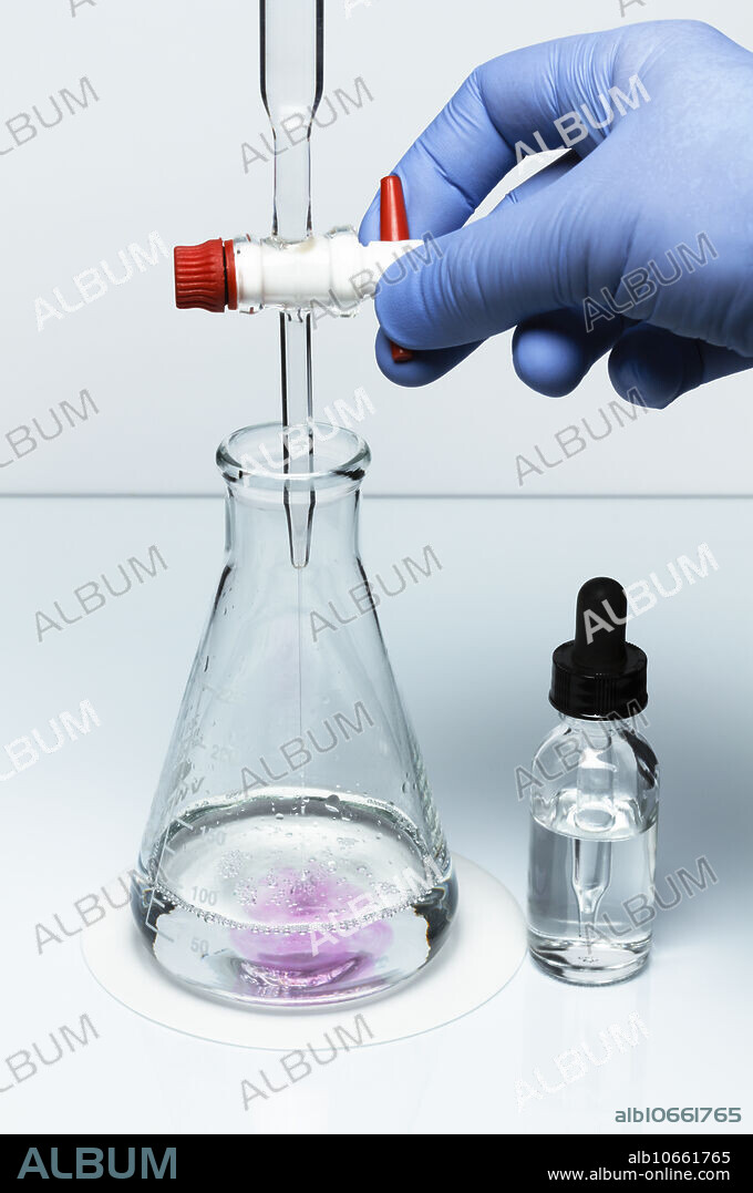 Acid-base titration, 3 of 7. In this sequence the Erlenmeyer flask initially contains 50 mL of sulfuric acid (H2SO4) solution of unknown concentration (0.04M was used here). Burette above it contains 0.1M solution of sodium hydroxide (NaOH), Photo 1. First, a couple of drops of phenolphthalein are added to Erlenmeyer flask and the acidic solution remains clear, Photo 2. Sodium hydroxide is then added gradually, turning the solution pink locally, Photo 3. The flask is swirled to mix the content, Photo 4, and the solution becomes clear. When the last drop is added, Photo 5, the solution retains pale pink colour, Photo 6. At this point (equivalence point) the volume of the base used is recorded and the initial concentration of the acidic solution is calculated. When sodium hydroxide is added in access beyond the equivalence point, the solution turns bright pink, Photo 7, indicating basic solution.