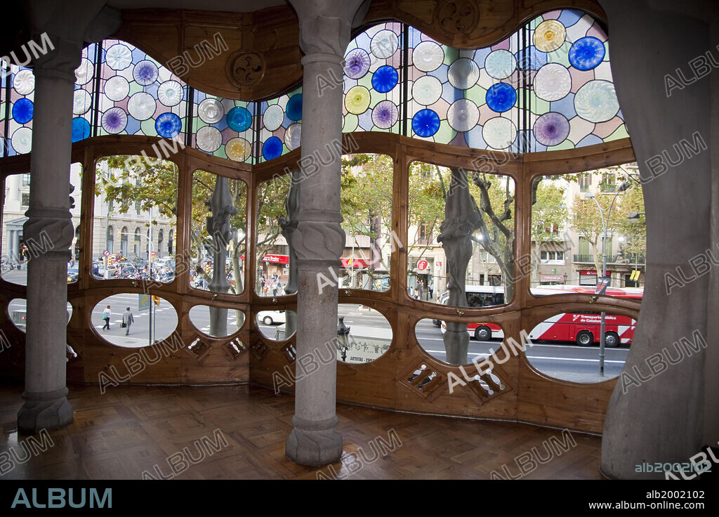 Casa Batllo was built in the year 1877 and remodeled by Antonio Gaudi in the years 1905-1907 for the Batllo family, living in the first floor. Because of the curved roof and skeletal organic quality, the local name for the building is House of Bones or House of the Dragon. A common theory is that the house represents the battle of Saint George with the dragon. The building is decorated in  Modernisme style, with a mosaic made of broken ceramic tiles in shades of orange, green and blue. The building was awarded as one of the three best buildings of the year 1906 by the Barcelona City Council; Batllo House is one of the seven works of Gaudi that were declared World Heritage sites by UNESCO in 1984. Along with Casa Ametllar and Casa Lleo-Morera, it makes up the three most important buildings in Barcelona's famous "Illa de la Discordia" ("Block of Discord") [formerly known as "Apple of Discord" (manzana de la Discordia)], noted for its unique modernist buildings.