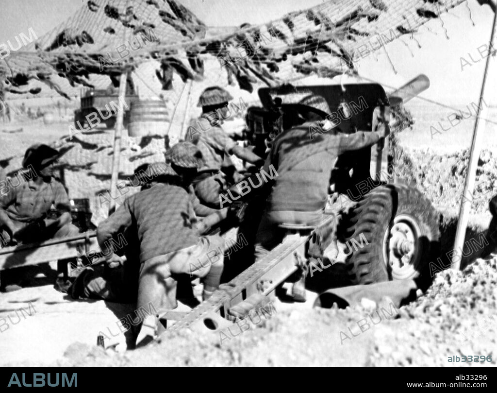 An Ordnance QF 25 pounder field gun from the british army in action at North Africas' desert during 1941-1942. The 25-pounder was considered the best artillery field piece during second world war.