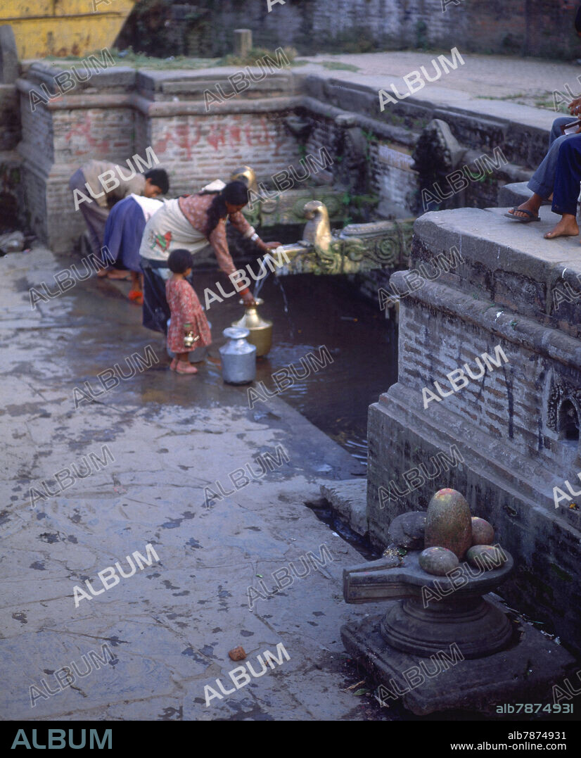 MUJER Y NIÑOS COGIENDO AGUA DE FUENTE CON CAÑOS EN BRONCE - Album alb7874931