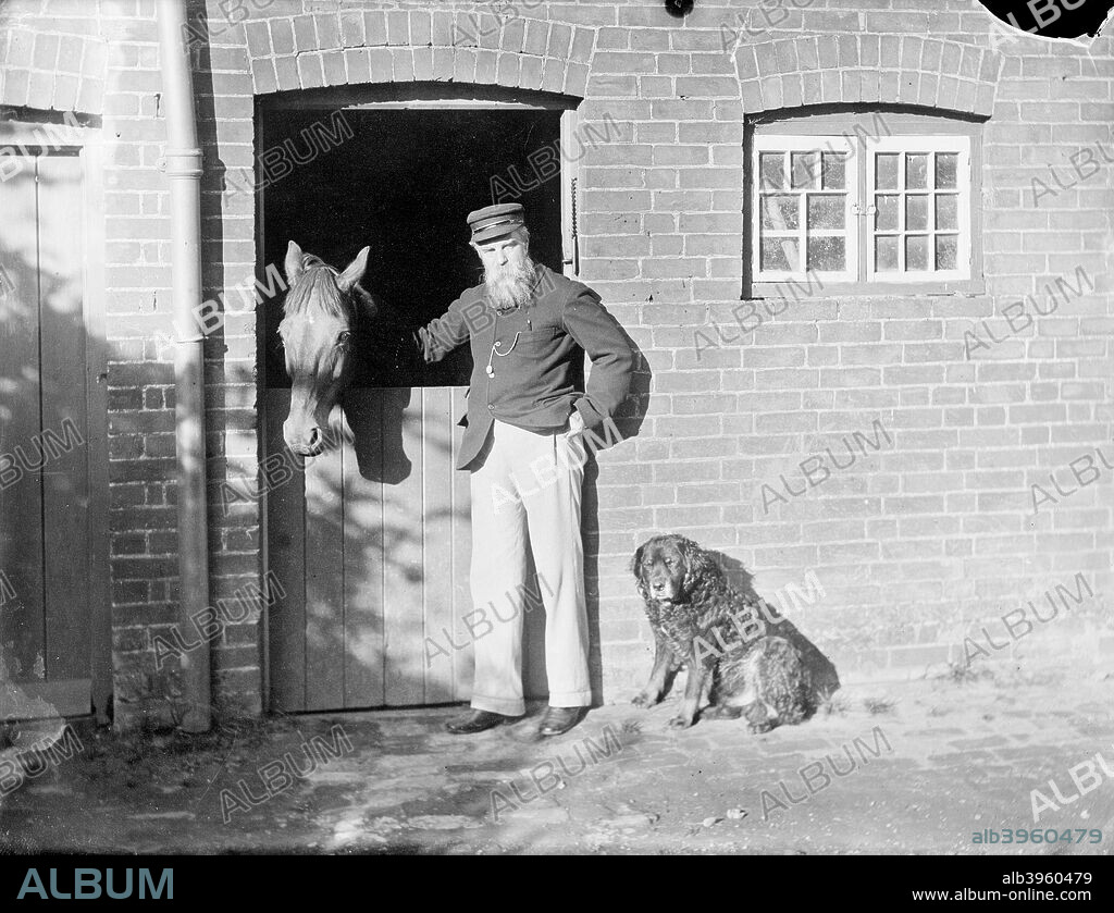 Rivera, Cowley Road, Cowley, Oxford, Oxfordshire, 1910. Henry Taunt with his horse and dog outside the stable at his house in Cowley which he leased and where he extended his business premises in 1889, eventually operating soley from the address from 1906.