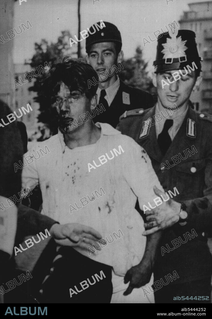 West Berlin Police Rescue Red Heckler Blood streaming down his face, a communist heckler is led to a first-aid station today, June 17, by West German police who rescued him from an angry mob outside West Berlin Town Hall where 20,000 West Berliners attended a rally to mark the anniversary of last year's rebellion in the city's soviet zone. Police had to rescue a number of hecklers in a similar manner. August 21, 1954. (Photo by Associated Press Photo).