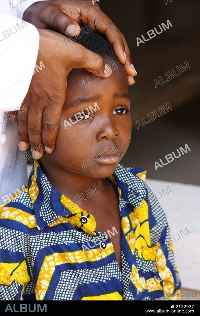 African child blessed by a priest.