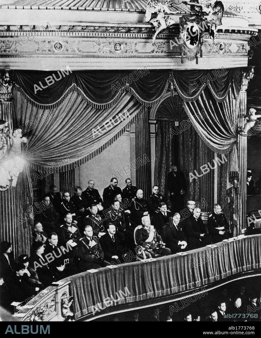 Adolf Hitler on the balcony of the Opera House. Chancellor of Germany Adolf Hitler seated on the balcony of the Opera House in occasion of the Heroes' Day to commemorate the fallen of the Great War. Also taking part in the evening German politician and military leader Hermann Goering, General Werner von Blomberg, President of Germany Paul von Hindenburg, Vice-Chancellor Franz von Papen, and Minister of the Interior Wilhelm Frick. Berlin, 12th March 1933.