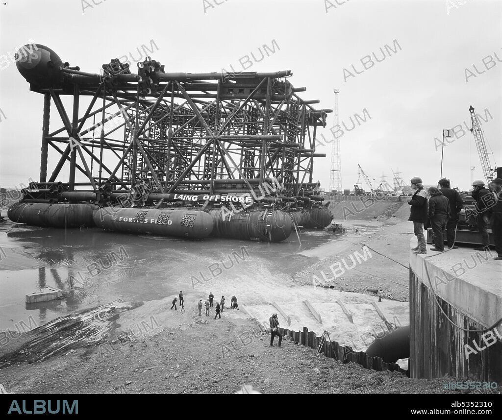 JOHN LAING PLC. A view of the oil platform Graythorp I lying in the dry dock at Graythorp during the flooding of the basin. In the early 1970s Laing Pipelines Offshore constructed the Graythorp fabrication yard and dry dock on the site of the old William Gray Shipyard. The company created a dry dock which was used for the construction of fixed platform North Sea drilling rigs for the BP North Sea Oil Project. Graythorp I had its christening ceremony on June 4th and was launched on Saturday 29th June 1974, heading off for the Forties Oil Field 250 miles away.