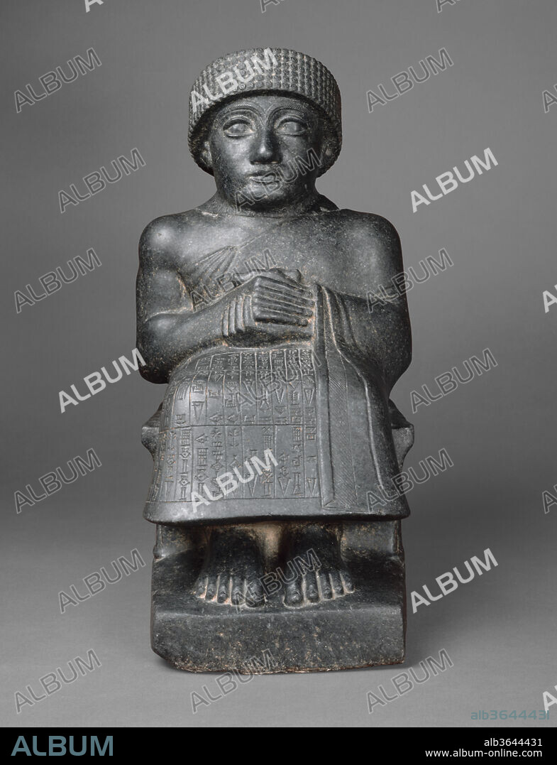 Statue of Gudea. Culture: Neo-Sumerian. Dimensions: 17 3/8 x 8 1/2 x 11 5/8 in. (44 x 21.5 x 29.5 cm). Date: ca. 2090 B.C..
The Akkadian Empire collapsed after two centuries of rule, and during the succeeding fifty years, local kings ruled independent city-states in southern Mesopotamia. The city-state of Lagash produced a remarkable number of statues of its kings as well as Sumerian literary hymns and prayers under the rule of Gudea (ca. 2150-2125 B.C.) and his son Ur-Ningirsu (ca. 2125-2100 B.C.). Unlike the art of the Akkadian period, which was characterized by dynamic naturalism, the works produced by this Neo-Sumerian culture are pervaded by a sense of pious reserve and serenity.
This sculpture belongs to a series of diorite statues commissioned by Gudea, who devoted his energies to rebuilding the great temples of Lagash and installing statues of himself in them. Many inscribed with his name and divine dedications survive. Here, Gudea is depicted in the seated pose of a ruler before his subjects, his hands folded in a traditional gesture of greeting and prayer. 
The Sumerian inscription on his robe reads as follows:
<i>When Ningirsu, the mighty warrior of Enlil, had established a courtyard in the city for Ningiszida, son of Ninazu, the beloved one among the gods; when he had established for him irrigated plots(?) on the agricultural land; (and) when Gudea, ruler of Lagas, the straightforward one, beloved by his (personal) god, had built the Eninnu, the White Thunderbird, and the..., his 'heptagon,' for Ningirsu, his lord, (then) for Nanse, the powerful lady, his lady, did he build the Sirara House, her mountain rising out of the waters. He (also) built the individual houses of (other) great gods of Lagas. For Ningiszida, his (personal) god, he built his House of Girsu. Someone (in the future) whom Ningirsu, his god - as my god (addressed me) has (directly) addressed within the crowd, let him not, thereafter, be envious(?) with regard to the house of my (personal) god. Let him invoke its (the house's) name; let such a person be my friend, and let him (also) invoke my (own) name. (Gudea) fashioned a statue of himself. "Let the life of Gudea, who built the house, be long." - (this is how) he named (the statue) for his sake, and he brought it to him into (his) house.</i>
This translation is derived from Edzard, Dietz-Otto. 1997. Gudea and his Dynasty. The Royal Inscriptions of Mesopotamia, Early Periods Volume 3/1. Toronto: University of Toronto Press, pp. 57-58.