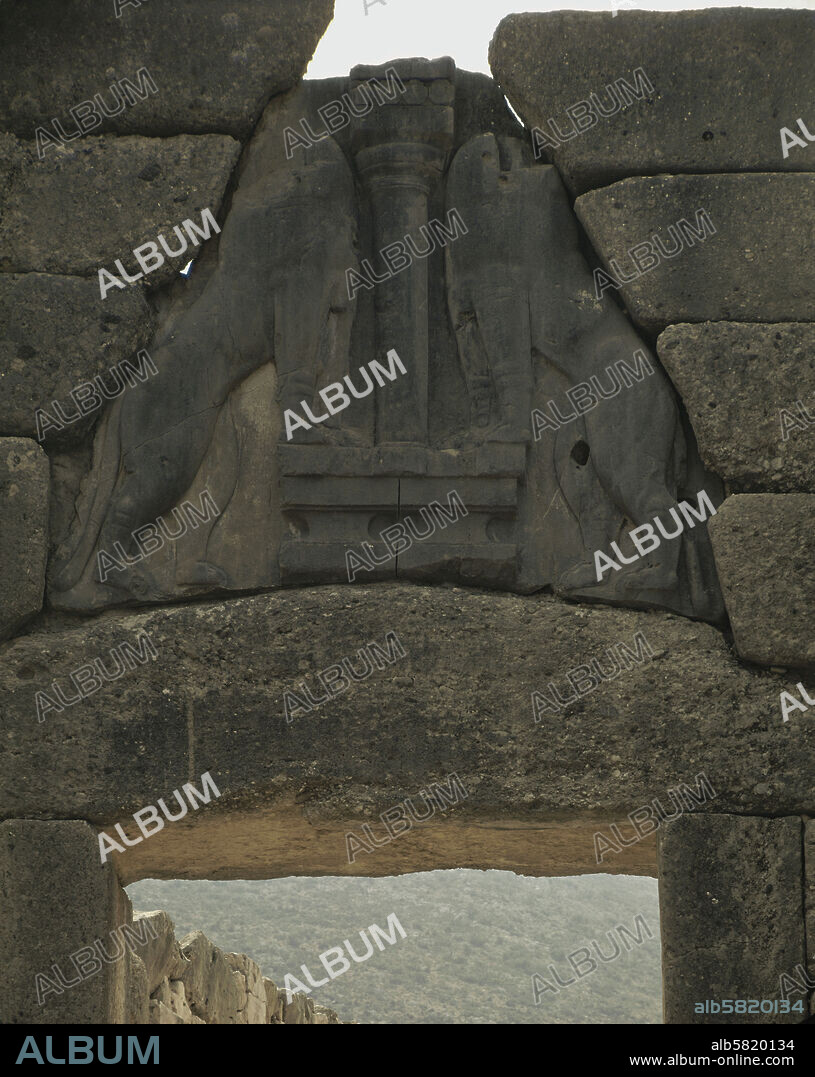 The Lions' Gate, Mycenae, formed by two monoliths, topped by a triangular slab of grey limestone with the relief of two lionesses. (1350 BCE).