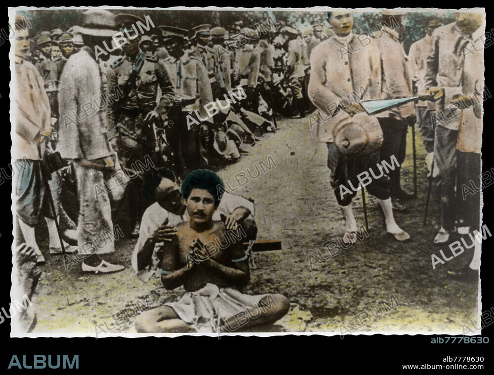 SIAM Execution under the reign of Rama VII: before two images of the sequence of a beheading, the victim is seated on the ground with his legs crossed and his hands clasped, his feet tied and his arms locked on a wood fixed to his back. A military platoon and a large audience are about to witness the execution; on the right, the executioner's weapon (see also # 42610). Siam, 1928.