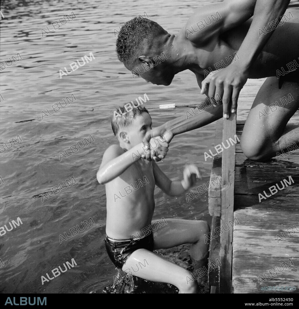 GORDON PARKS. Southfields, New York. Interracial activities at Camp Nathan Hale, where children are aided by the Methodist Camp Service. A scene at the swimming dock.