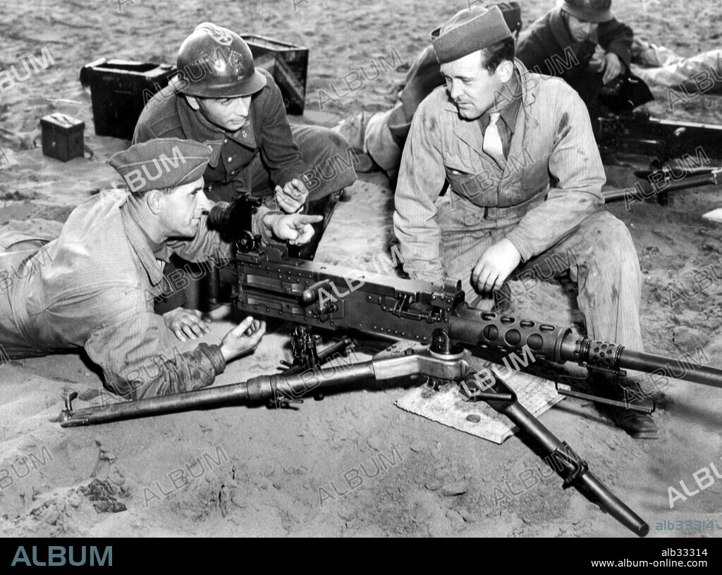 French officers and men learn to use US arms in North Africa. A french soldier observes the american 50 calibre machine gun in action on a firing range. French soldiers are being supplied with US weapons and equipment.