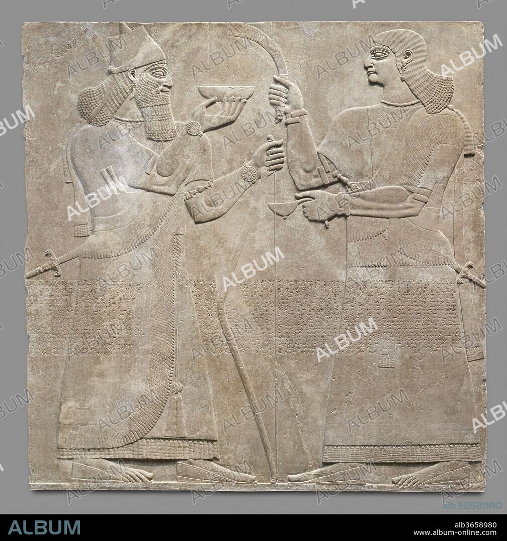 Relief panel. Culture: Assyrian. Dimensions: 92 1/4 x 92 x 4 1/2 in. (234.3 x 233.7 x 11.4 cm). Date: ca. 883-859 B.C..
This relief, from the palace of the Assyrian king Ashurnasirpal II (r. ca. 883-859 B.C.), depicts a king, probably Ashurnasirpal himself, and an attendant. The two larger-than-life-sized figures are carved in low relief, and as with other reliefs in the palace featuring the image of the king, the carving is particularly fine and shows special attention to detail. The panel joins a second relief that shows a further attendant, also facing the king, and a winged supernatural protective figure. Together, the two panels show the king flanked by his human courtiers, just as in other scenes he or the Assyrian Sacred Tree are flanked by human and eagle-headed winged guardian figures.
The king is immediately identifiable by his crown, a distinctive truncated cone with a smaller cone emerging from the center, with a long 'streamer' hanging from its back. He is also recognizable by his luxuriant beard, and in the relief's original state would have been further distinguished by his clothing, more elaborately embroidered than that of any other figure. The pigment that originally colored these reliefs is now lost, but the embroidery is still faintly visible in the form of fine inscised lines made by the sculptors over most areas of the king's clothing. The king wears elaborate jewelry, including rosette bracelets, thick armlets worn above the elbow, large pendant earrings, and a necklace whose beads and spacers would probably have consisted of semiprecious stones and gold. The king carries a sword on his left hip, as well as two daggers tucked into his clothing, and in his left hand holds the tip of a bow. In his right hand, balanced on his fingertips, is a shallow bowl. In other reliefs the bowl contains wine and is used for pouring libations, for example on the bodies of slain animals following a royal hunt. Here, however, there is no apparent object for the libation. The relief comes from an area of the palace that seems to have held sarcophagi and might have been devoted to the cult of royal ancestors, and one possibility is that the libation is here being poured for the dead. For similar reasons, while it is normally thought that all such images of the king represent Ashurnasirpal, it has also been suggested that some may represent ancestral kings. 
The second figure on the relief is beardless, and probably represents a eunuch. He is richly dressed, with jewelry including rosette bracelets, armbands, a collar of beads, probably of semiprecious stone with gold spacers, pendant earrings, and a crescent-shaped pectoral. At the ends of his short sleeves are bands of incised plant motifs representing embroidery; another incised band below the waist shows further plants but also birds, possibly ostriches. He carries a sword whose scabbard, like the king's, ends in the image of two roaring lions. At the sword's hilt another lion head can be seen; an object in the Metropolitan Museum's collection may be just such a hilt . In his right hand the eunuch holds a fly-whisk whose handle is carved in the shape of a ram's head. The object in his left hand may be an oil lamp, though it has also been suggested that it might be a ladle to replenish the wine in the bowl held by the king. Its handle terminates in the head of a snake, or more likely a fantastic composite creature, called Mushhushshu, associated with the god Ashur. 
A distinctive feature of the Northwest Palace is the so-called Standard Inscription that ran across the middle of every relief, often cutting across the imagery. The inscription, carved in cuneiform script and written in the Assyrian dialect of the Akkadian language, lists the achievements of Ashurnasirpal II (r. 883-859 B.C.), the builder of the palace. After giving his ancestry and royal titles, the Standard Inscription describes Ashurnasirpal's successful military campaigns to east and west and his building works at Nimrud, most importantly the construction of the palace itself. The inscription is thought to have had a magical function, contributing to the divine protection of the king and the palace.