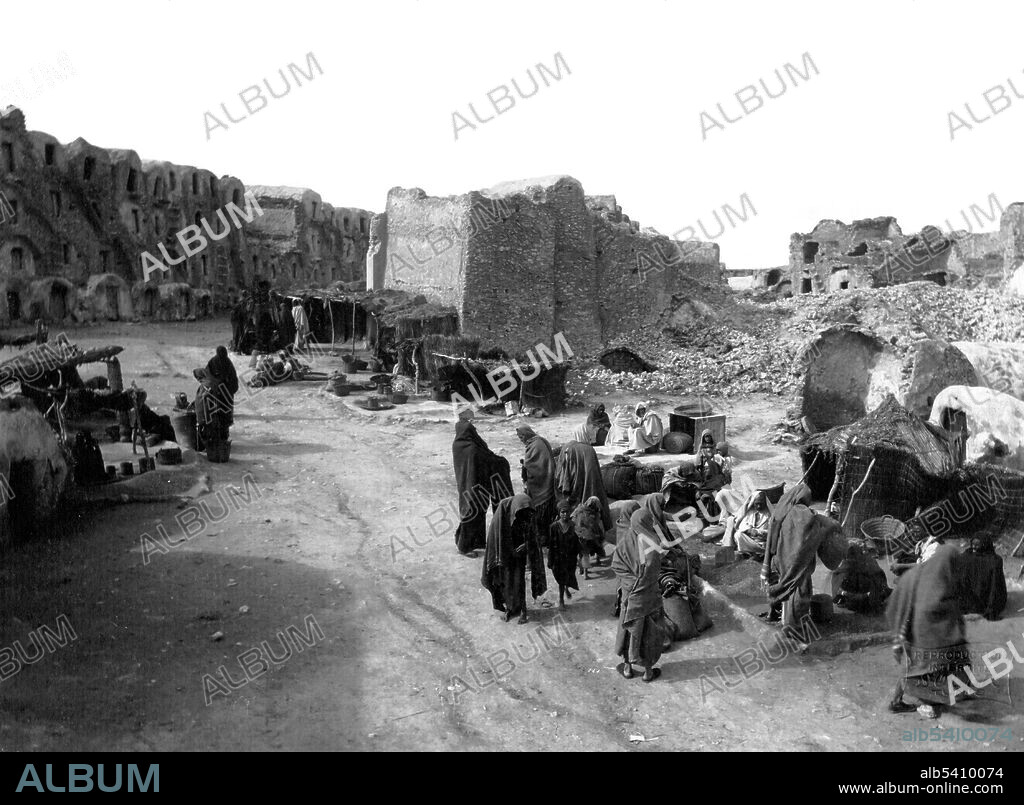 Medenine street market. Medenine is the major town in south-eastern Tunisia, south of the port of Gabès and the Island of Djerba, on the main route to Libya. In pre-colonial times, Medenine was already the most important trading center in the south, attracting merchants from all over North Africa and even from Bornu, to the south of the Sahara. The Ksar housed the central granaries of the various nomadic Berber tribes of the region. F. Soler, circa 1880 and 1900.